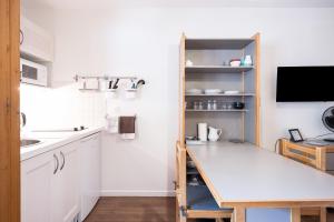 a small kitchen with a table and a sink at Studio Grand Chalet in Brides-les-Bains