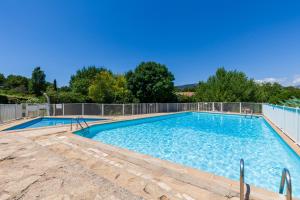 a swimming pool with a fence around it at Jolie Maison Proche Plage in Toulon