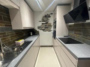 a kitchen with a sink and a counter top at 4 Studio House Ambleside in Ambleside