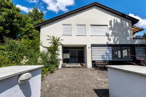 a white house with a driveway in front of it at Seesucht in Gaienhofen