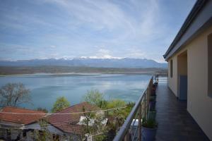 a balcony with a view of a lake and mountains at Ulza Lake Escape in Ulëz