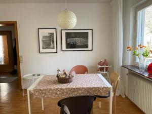 a dining room table with a basket of flowers on it at Haus am Reithagen in Hofgeismar +27 photos