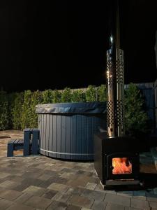 a fireplace sitting on a patio at night at Harmony Cottage in Kyiv