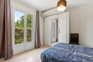 a bedroom with a bed and a large window at Villa Les Brés in Bauduen +20 photos