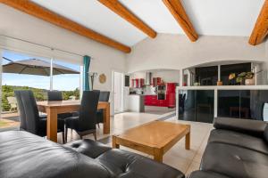 a living room with a couch and a table and a dining room at Villa Les Brés in Bauduen