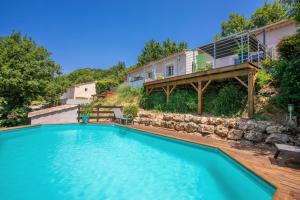 a swimming pool in front of a house at Villa Les Brés in Bauduen