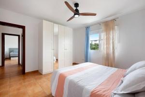 a bedroom with a bed and a ceiling fan at Mayantigo in Juan Gopar +30 photos