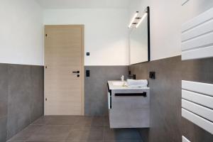 a bathroom with a sink and a mirror at Haus Weinblick Apt 5 in Magrè allʼ Adige