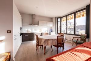 a kitchen and dining room with a table and chairs at Annecy - Le 10 in Annecy