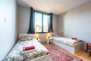 a bedroom with two beds and a window at Annecy - Le 10 in Annecy