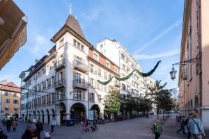a large white building with people walking around it at Annecy - Le 10 in Annecy
