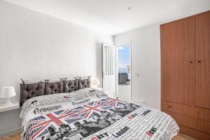 a bedroom with a bed with a british flag bedspread at Oramas Secret Cellar – Casa Rural in Arico
