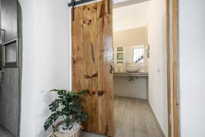 a bathroom with a wooden door and a sink at Oramas Secret Cellar – Casa Rural in Arico +17 photos