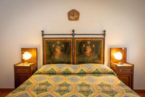 a bedroom with a bed with two night stands and two lamps at La Sassetta in Bibbona