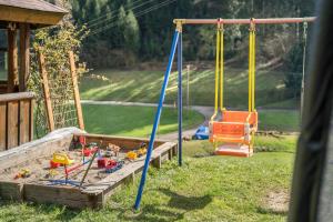 two swings in a yard next to a house at Jorchenhof in Hofstetten