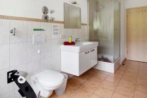 a bathroom with a toilet and a sink at Sport Rees - Ferienwohnung Melanie in Oberried +26 photos