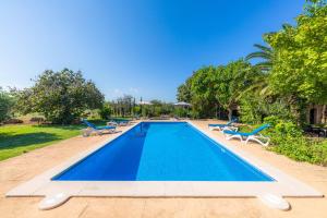 a swimming pool with lounge chairs and a resort at Can Sua in Artá