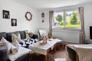 a living room with a couch and a table at Sport Rees - Ferienwohnung Melanie in Oberried