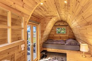 a bedroom in a tiny house with a bed in it at Campingpod Auf Der Alpakawiese in Arnsberg