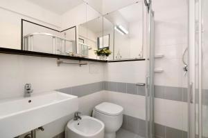 a bathroom with a toilet and a sink and a mirror at Nonna Adele in Sestri Levante +19 photos