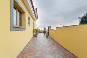 a corridor of a building with a yellow wall at Casa Yaraina in Firgas
