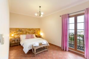 a bedroom with a bed and a large window at Casa Yaraina in Firgas