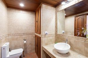 a bathroom with a sink and a toilet and a mirror at Casa Yaraina in Firgas +18 photos