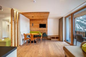 a living room with a table and chairs and a couch at Stoana Apt 4-2 in San Giacomo