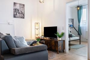 a living room with a couch and a tv at Mäxle's Loft Winzeln in Winzeln