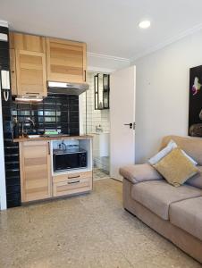 a living room with a couch and a kitchen at Vista al Mar in Denia