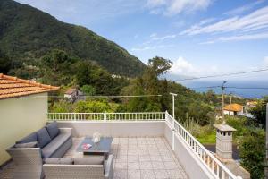 a balcony with a view of the ocean at Casa Estrela Do Norte in Ponta Delgada
