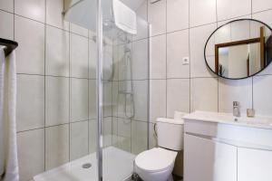 a bathroom with a shower and a toilet and a sink at Casa Estrela Do Norte in Ponta Delgada +16 photos