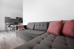a couch with two pillows on it in a living room at La Corte A1 in Antigua