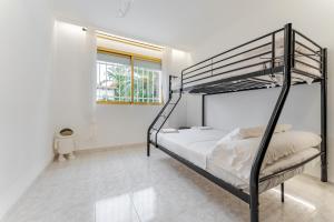 a bedroom with a bunk bed in a white room at Oasis Salou Pool Beach and Bbq in Salou +37 photos