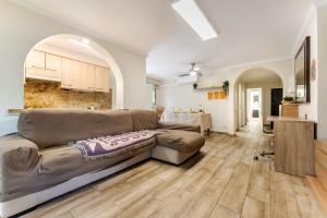 a living room with a couch and a kitchen at Oasis Salou Pool Beach and Bbq in Salou