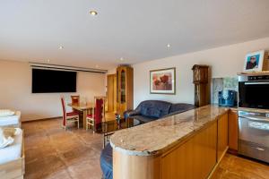 a living room with a kitchen and a dining room at Haus am Bächel 2 in Obersasbach