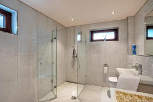 a bathroom with a shower and a sink at Haus am Bächel 2 in Obersasbach +18 photos