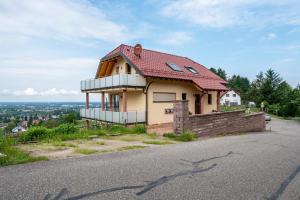 a house with a red roof on top of a hill at Haus am Bächel 2 in Obersasbach