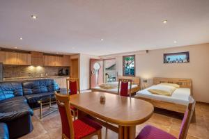 a living room with a bed and a table at Haus am Bächel 2 in Obersasbach