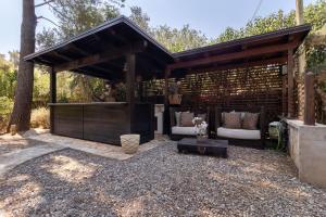 a wooden pavilion with two couches and a table at Villa Lorenz in Putignano