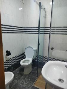 a bathroom with a toilet and a sink at Oued laou beach in Oued Laou +13 photos