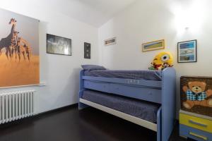a childs bedroom with a blue bunk bed at Villa Lorenz in Putignano