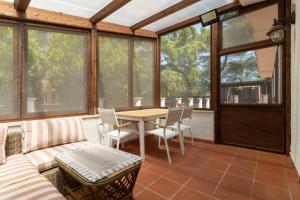a screened in porch with a table and chairs at Villa Lorenz in Putignano