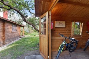 a bike parked outside of a wooden cabin at Blockhütte in Fürstenwalde
