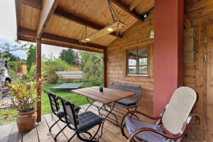 a wooden patio with a wooden table and chairs at Blockhütte in Fürstenwalde