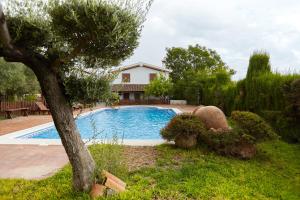 a swimming pool in the yard of a house at La Acacia in Martos