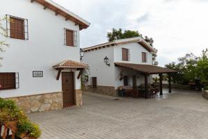 a white building with a patio in front of it at La Acacia in Martos