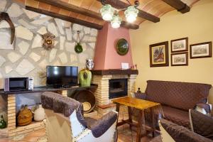 a living room with a couch and a fireplace at La Acacia in Martos