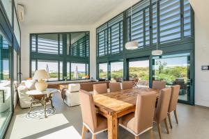 a dining room with a wooden table and chairs at Villa Canutells Ref 27 in Mahón