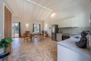 a kitchen and dining room with a table and chairs at Elysium Living in Gouvia